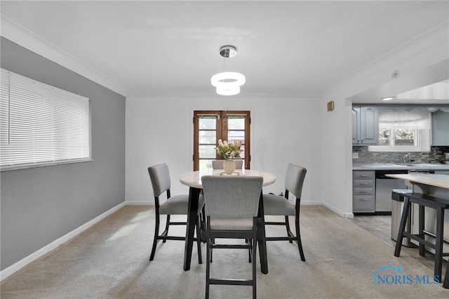 2923 Powhattan Pkwy, Toledo, OH 43606 - dining room with crown molding, light carpet, and baseboards