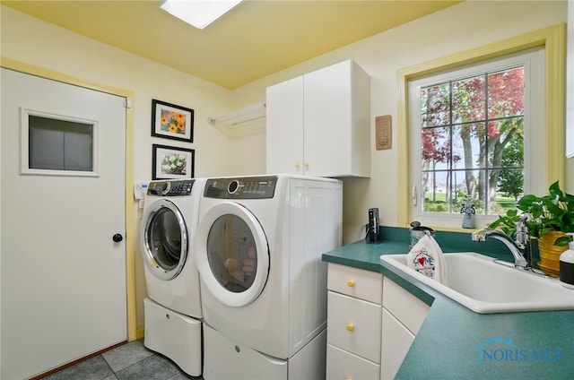 3145 Shoreland Ave, Toledo, OH 43611 - washroom with cabinet space, washer and dryer, and tile patterned floors