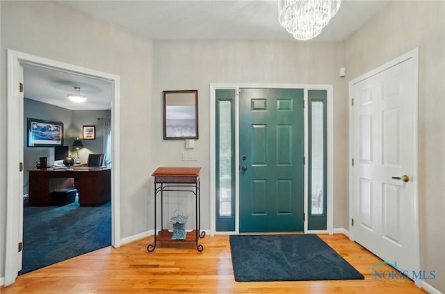 3145 Shoreland Ave, Toledo, OH 43611 - entryway featuring wood finished floors, a chandelier, and baseboards