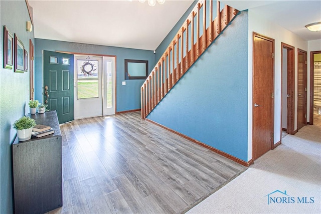 556 S Lathrop Rd, Swanton, OH 43558 - foyer entrance featuring baseboards, stairway, and wood finished floors