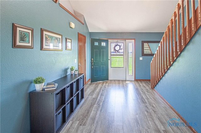 556 S Lathrop Rd, Swanton, OH 43558 - foyer featuring lofted ceiling, stairway, a textured wall, baseboards, and wood finished floors