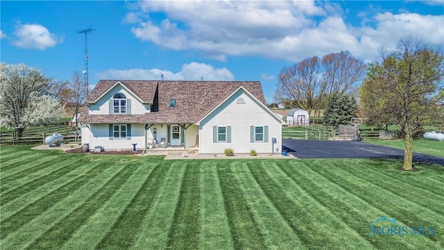 556 S Lathrop Rd, Swanton, OH 43558 - back of house featuring an outbuilding, a shed, a yard, and fence