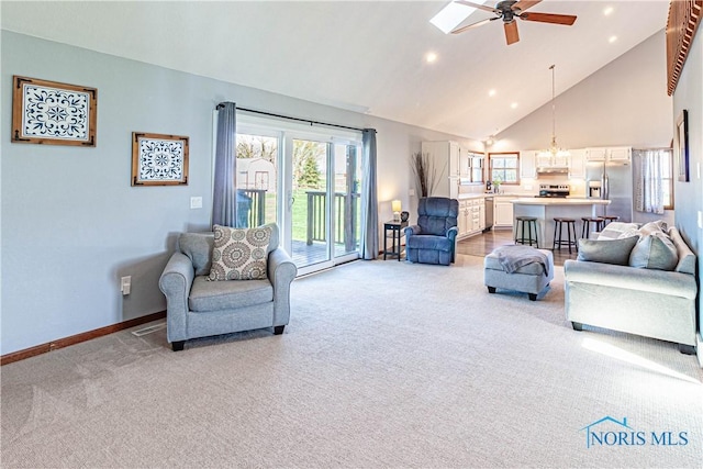 556 S Lathrop Rd, Swanton, OH 43558 - living room with high vaulted ceiling, baseboards, light colored carpet, and ceiling fan with notable chandelier