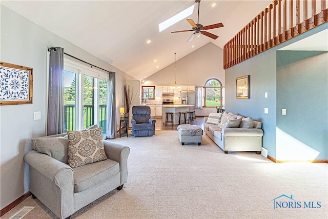 556 S Lathrop Rd, Swanton, OH 43558 - living area featuring a ceiling fan, high vaulted ceiling, baseboards, and light carpet