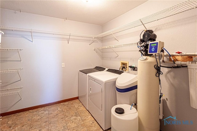 556 S Lathrop Rd, Swanton, OH 43558 - clothes washing area featuring baseboards, separate washer and dryer, and laundry area