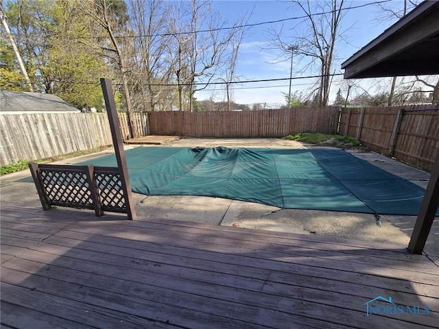 view of swimming pool with a fenced in pool, a deck, and a fenced backyard