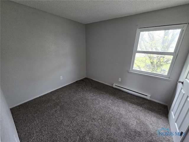 carpeted spare room with a textured ceiling, baseboards, and a baseboard radiator
