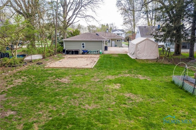 rear view of house with a yard
