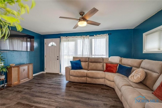 living area with ceiling fan, dark wood-style flooring, and baseboards