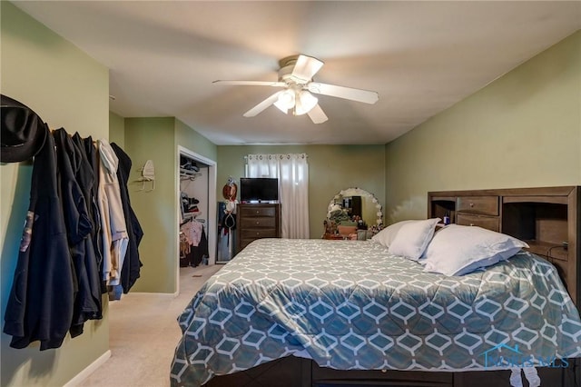bedroom with a ceiling fan, a closet, and light carpet