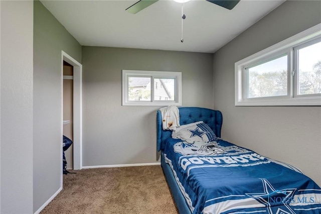 bedroom featuring baseboards, a ceiling fan, and carpet flooring