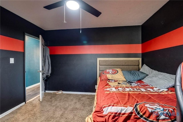 carpeted bedroom featuring a ceiling fan and baseboards