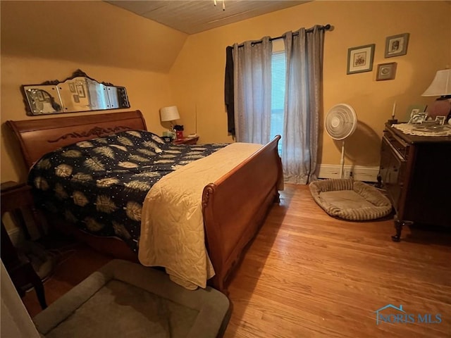 825 S Clinton St, Defiance, OH 43512 - bedroom with wood finished floors and lofted ceiling