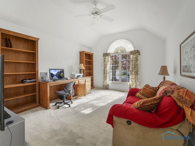 home office featuring a ceiling fan, light colored carpet, and vaulted ceiling
