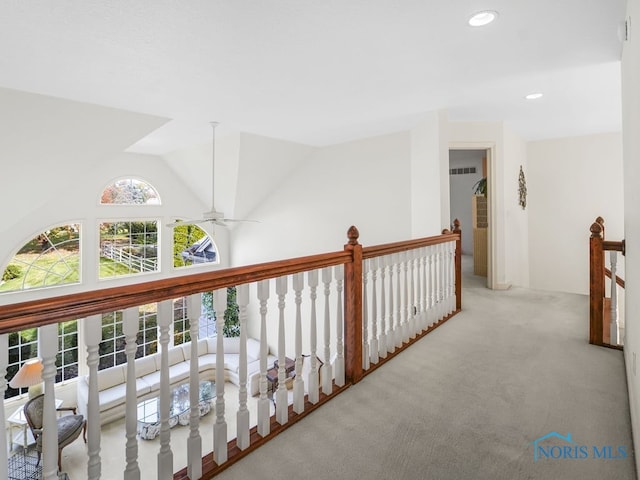 hall featuring recessed lighting, carpet, vaulted ceiling, an upstairs landing, and visible vents