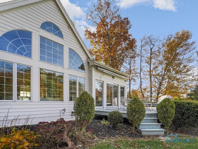view of property exterior featuring a wooden deck