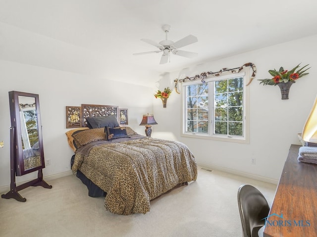 carpeted bedroom featuring visible vents, multiple windows, and baseboards