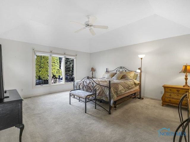 carpeted bedroom featuring a ceiling fan, lofted ceiling, and baseboards