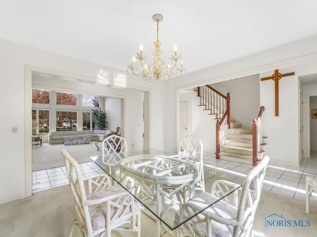 dining room featuring an inviting chandelier, stairway, light tile patterned floors, and light carpet