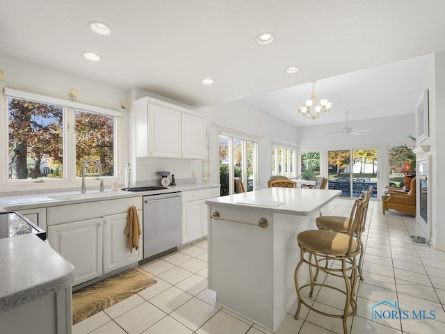 kitchen featuring a sink, an inviting chandelier, dishwasher, and plenty of natural light