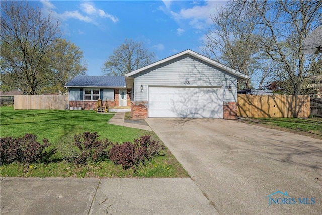 ranch-style house featuring a garage, fence, a front yard, brick siding, and concrete driveway