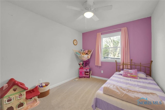 bedroom with baseboards, light colored carpet, ceiling fan, and visible vents