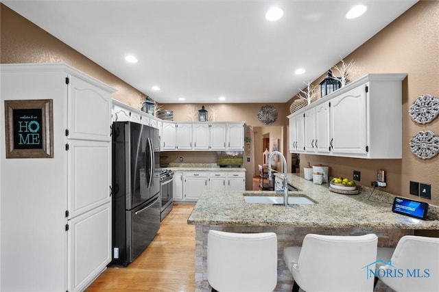 6170 S Winding Way, Swanton, OH 43558 - kitchen featuring white cabinets, a peninsula, appliances with stainless steel finishes, and a sink