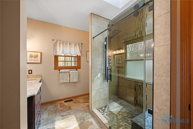 6170 S Winding Way, Swanton, OH 43558 - full bathroom with a stall shower, stone finish flooring, vanity, and baseboards