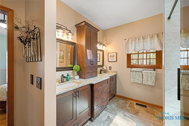 6170 S Winding Way, Swanton, OH 43558 - full bathroom featuring double vanity, visible vents, baseboards, and a sink