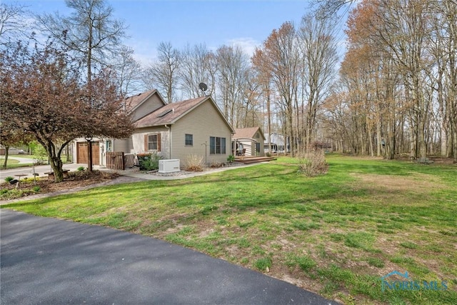 6170 S Winding Way, Swanton, OH 43558 - view of home's exterior with a garage and a lawn