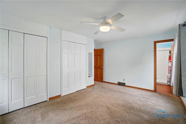 864 Cherry Ln, Waterville, OH 43566 - unfurnished bedroom featuring carpet, two closets, baseboards, and ceiling fan