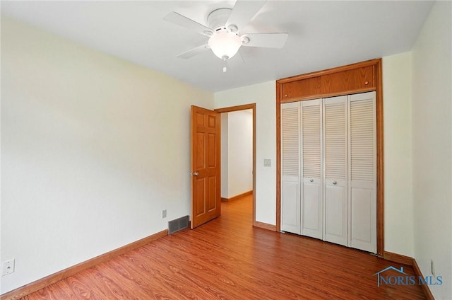 864 Cherry Ln, Waterville, OH 43566 - unfurnished bedroom with wood finished floors, baseboards, a closet, and a ceiling fan