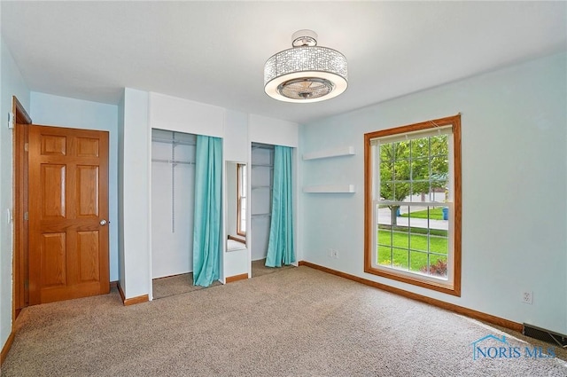864 Cherry Ln, Waterville, OH 43566 - unfurnished bedroom featuring carpet flooring, baseboards, and two closets