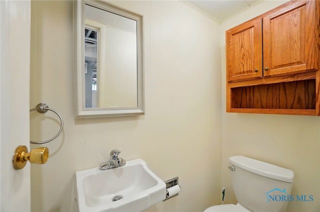 864 Cherry Ln, Waterville, OH 43566 - half bathroom with a sink, toilet, and crown molding