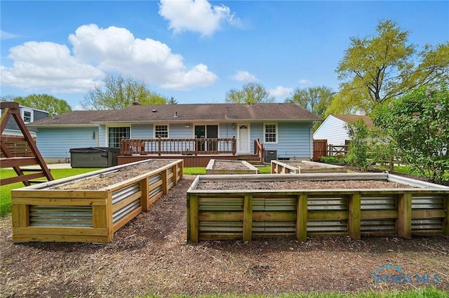 864 Cherry Ln, Waterville, OH 43566 - back of house featuring a vegetable garden, a wooden deck, and a hot tub