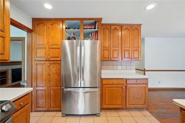 864 Cherry Ln, Waterville, OH 43566 - kitchen featuring appliances with stainless steel finishes, brown cabinets, light countertops, light tile patterned flooring, and recessed lighting