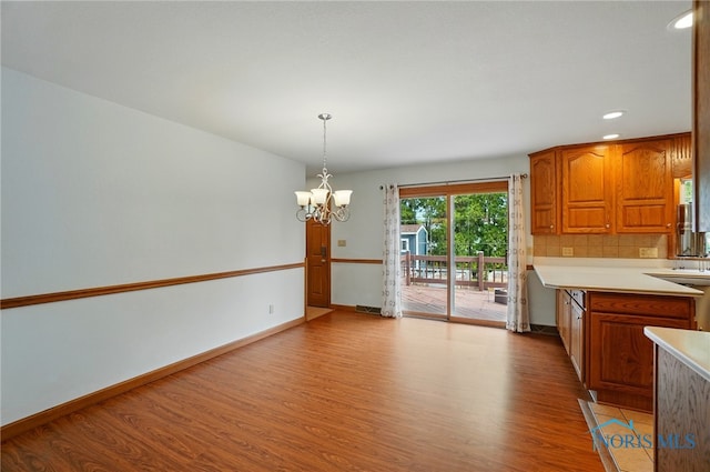 864 Cherry Ln, Waterville, OH 43566 - unfurnished dining area featuring wood finished floors, a chandelier, recessed lighting, and baseboards