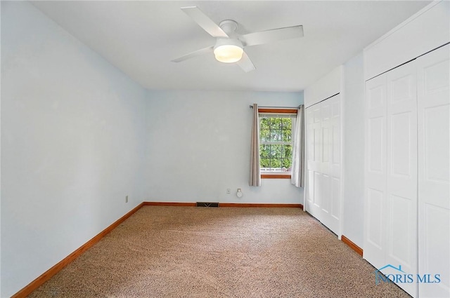 864 Cherry Ln, Waterville, OH 43566 - unfurnished bedroom with carpet flooring, baseboards, two closets, and ceiling fan