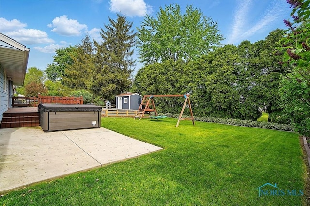 864 Cherry Ln, Waterville, OH 43566 - view of yard with a playground, a patio, a hot tub, a storage unit, and an outdoor structure