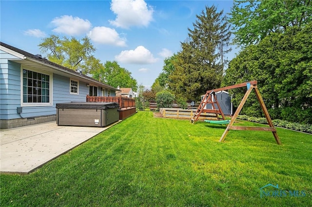 864 Cherry Ln, Waterville, OH 43566 - view of green lawn with a hot tub, a playground, and a patio area