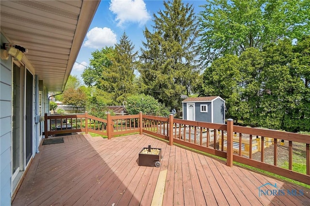 864 Cherry Ln, Waterville, OH 43566 - wooden terrace with a shed, an outdoor structure, and view of scattered trees