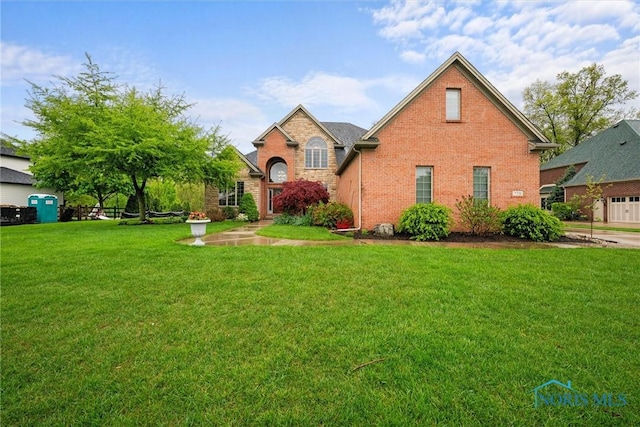 traditional-style home with brick siding and a front lawn