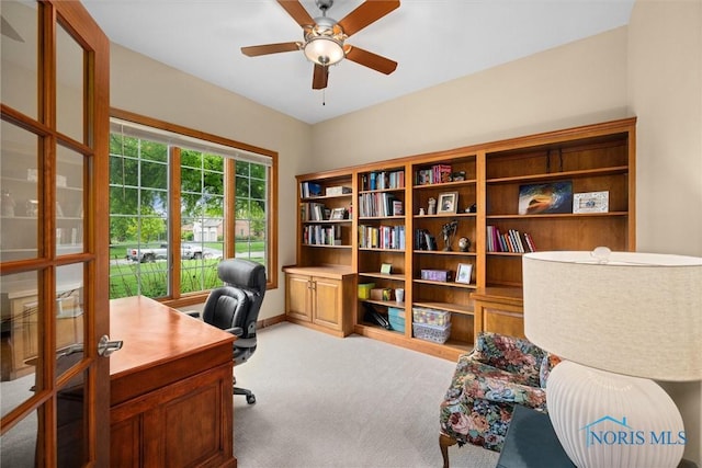 carpeted office featuring ceiling fan