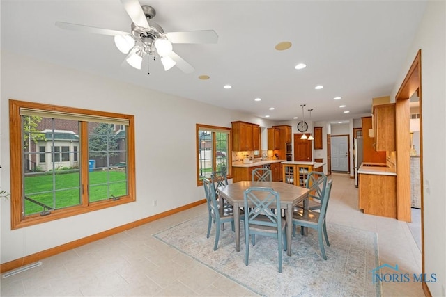 dining area featuring plenty of natural light, baseboards, recessed lighting, and ceiling fan