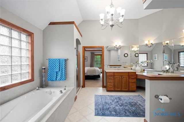 ensuite bathroom featuring a chandelier, a bath, vanity, tile patterned floors, and lofted ceiling