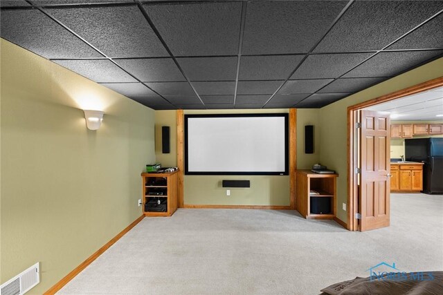 home theater with light colored carpet and baseboards