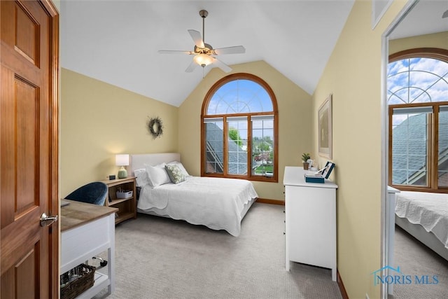 bedroom with carpet, lofted ceiling, and a ceiling fan