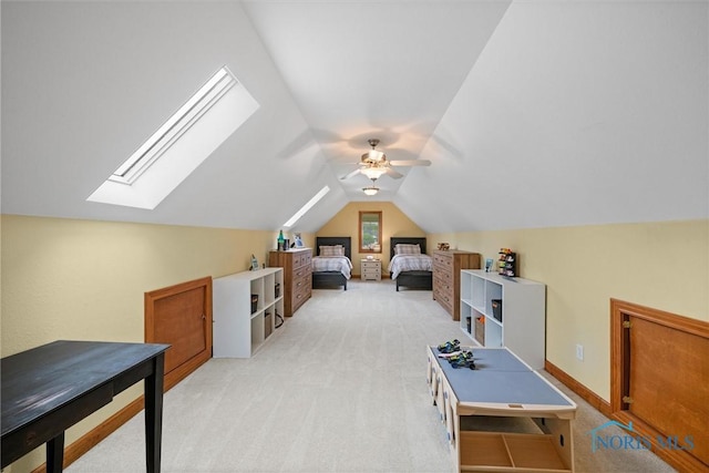 bedroom with light carpet, a skylight, vaulted ceiling, and a ceiling fan