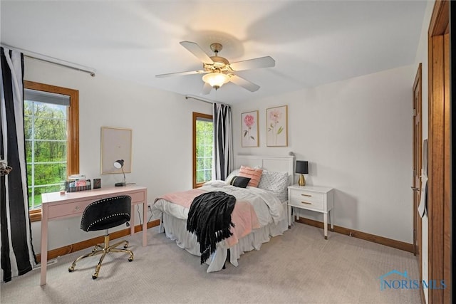 carpeted bedroom with baseboards and ceiling fan