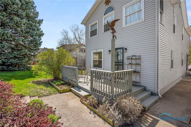 back of property with a wooden deck